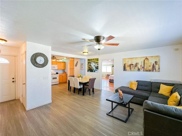 45439 Lorimer Ave, Lancaster, CA 93534 - living area with a ceiling fan, light wood finished floors, and baseboards