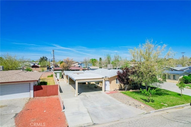 45439 Lorimer Ave, Lancaster, CA 93534 - single story home featuring concrete driveway, stucco siding, a carport, and a residential view