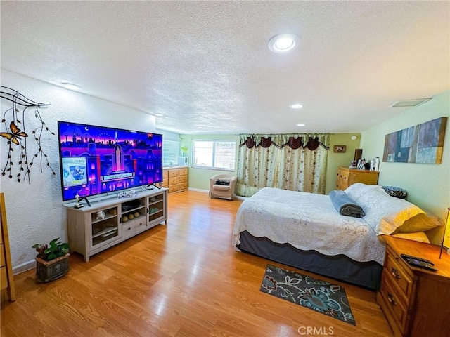 45439 Lorimer Ave, Lancaster, CA 93534 - bedroom featuring a textured ceiling, wood finished floors, recessed lighting, baseboards, and a textured wall