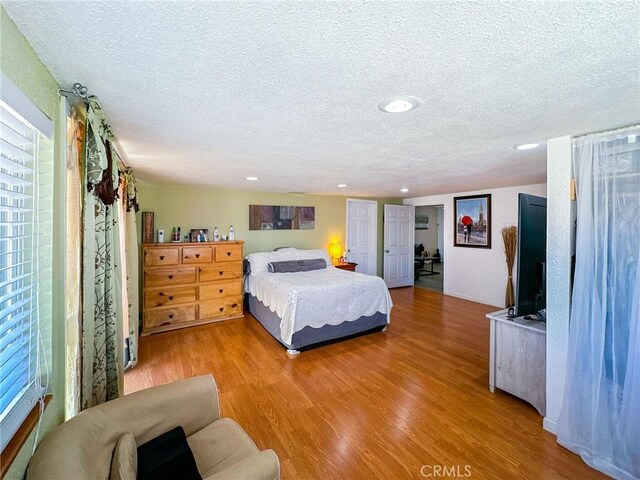 45439 Lorimer Ave, Lancaster, CA 93534 - bedroom featuring a textured ceiling, wood finished floors, and recessed lighting