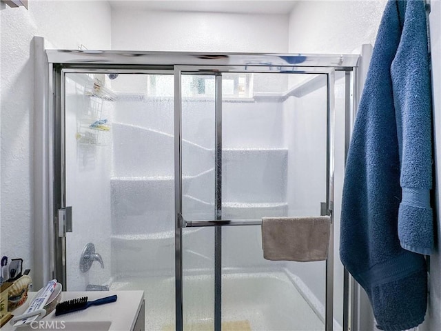 45439 Lorimer Ave, Lancaster, CA 93534 - bathroom featuring a textured wall, an enclosed shower, and vanity
