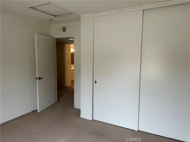 2802 Via Diego, Carlsbad, CA 92010 - unfurnished bedroom featuring light colored carpet, a closet, a textured ceiling, and attic access