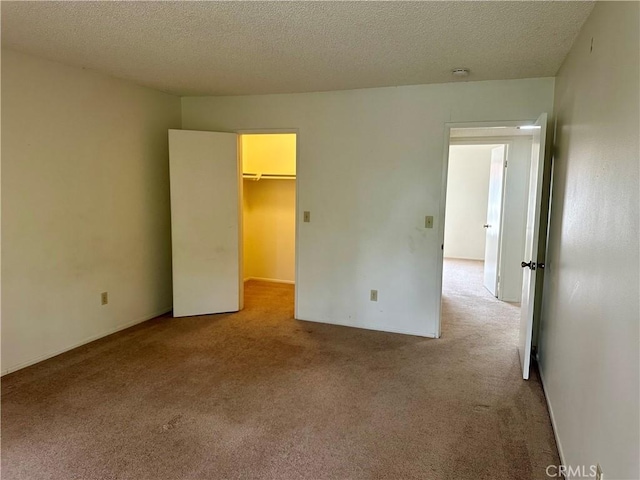2802 Via Diego, Carlsbad, CA 92010 - unfurnished bedroom with light carpet, a walk in closet, and a textured ceiling