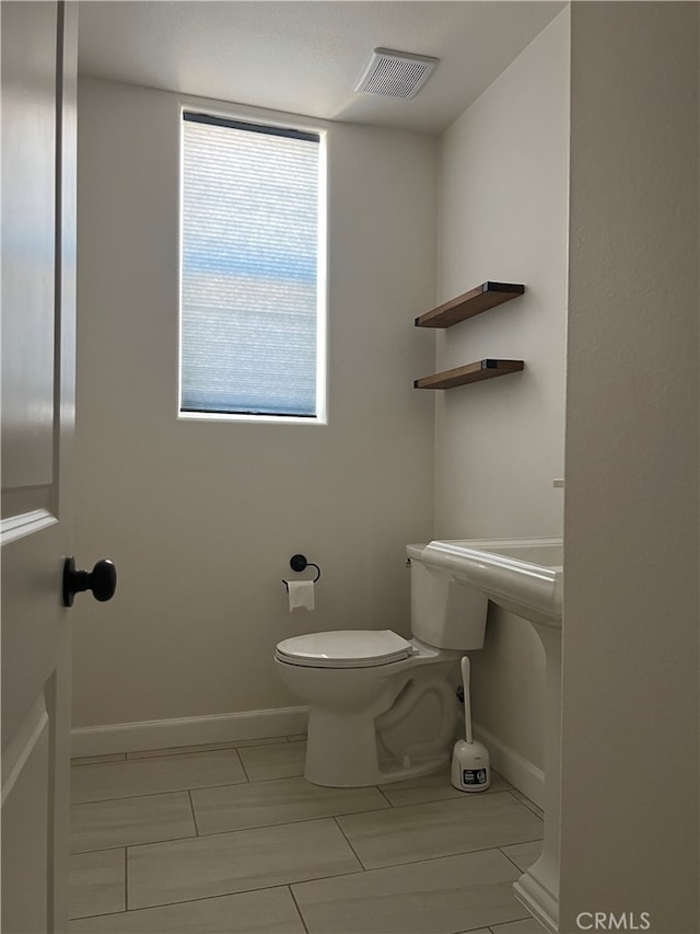 7448 Del Rio Vis, Yucca Valley, CA 92284 - half bathroom featuring baseboards and toilet