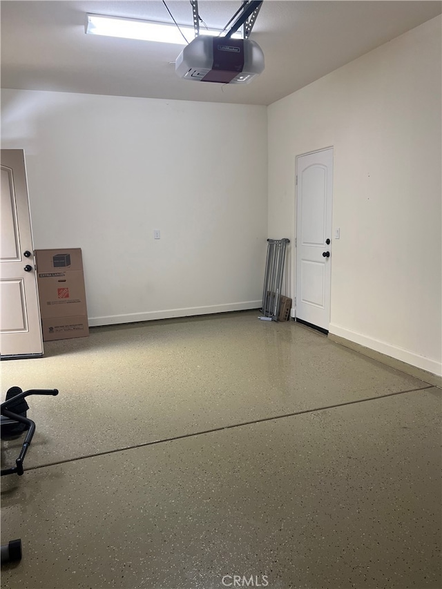 7448 Del Rio Vis, Yucca Valley, CA 92284 - garage with a garage door opener and baseboards