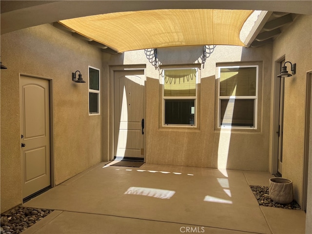 7448 Del Rio Vis, Yucca Valley, CA 92284 - entrance to property featuring a patio area and stucco siding