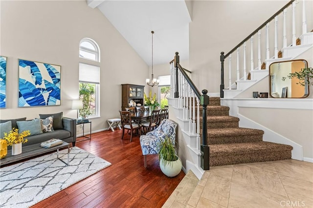 2074 Redgrove Way, Upland, CA 91784 - staircase with high vaulted ceiling, a chandelier, plenty of natural light, beamed ceiling, and hardwood / wood-style floors