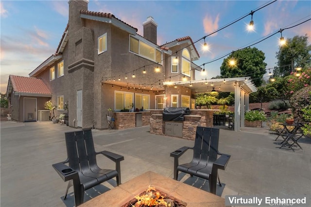 2074 Redgrove Way, Upland, CA 91784 - patio terrace at dusk with an outdoor fire pit, area for grilling, and a patio