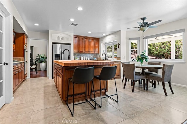 2074 Redgrove Way, Upland, CA 91784 - kitchen with tasteful backsplash, a kitchen bar, a ceiling fan, wooden counters, and recessed lighting