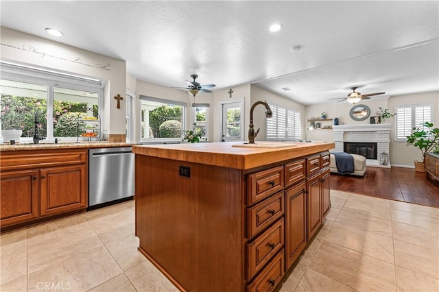 2074 Redgrove Way, Upland, CA 91784 - kitchen with dishwasher, a ceiling fan, butcher block counters, open floor plan, and a center island with sink