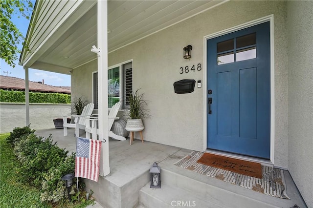 3848 Ocana Ave, Long Beach, CA 90808 - view of exterior entry with stucco siding and covered porch