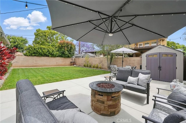 3848 Ocana Ave, Long Beach, CA 90808 - fenced backyard featuring a storage unit, a patio area, and an outdoor living space with a fire pit