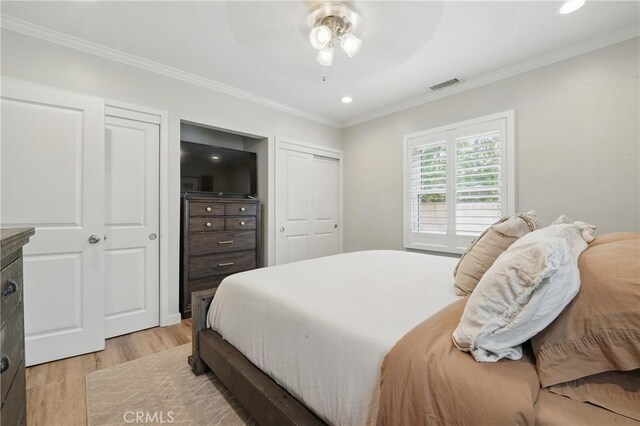 3848 Ocana Ave, Long Beach, CA 90808 - bedroom with light wood finished floors, two closets, ornamental molding, recessed lighting, and a ceiling fan