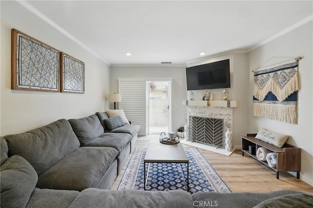 3848 Ocana Ave, Long Beach, CA 90808 - living area featuring crown molding, wood finished floors, recessed lighting, and a tiled fireplace