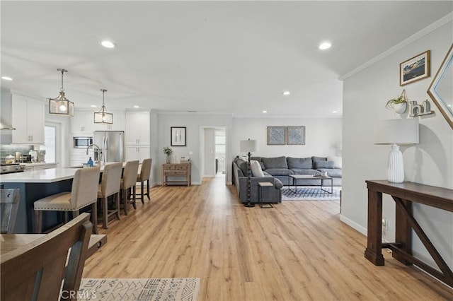 3848 Ocana Ave, Long Beach, CA 90808 - living area featuring light wood-style flooring, recessed lighting, and crown molding
