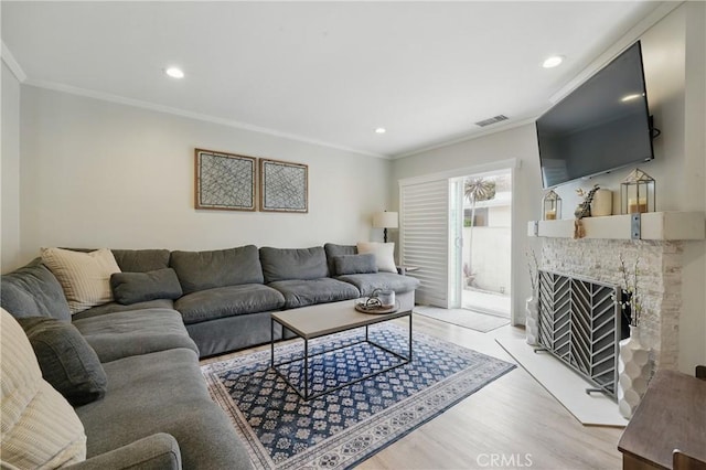 3848 Ocana Ave, Long Beach, CA 90808 - living room featuring light wood-style flooring, crown molding, a fireplace, and recessed lighting