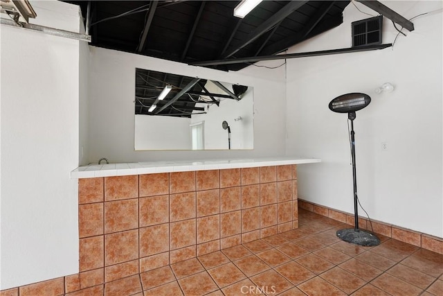 1440 E Abila St, Carson, CA 90745 - bar area featuring baseboards, lofted ceiling, and tile patterned floors