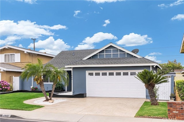 1440 E Abila St, Carson, CA 90745 - view of front of house with a shingled roof, driveway, a garage, a front lawn, and stucco siding