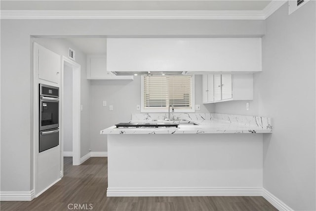 1440 E Abila St, Carson, CA 90745 - kitchen featuring oven, baseboards, white cabinets, dark wood-style flooring, and crown molding