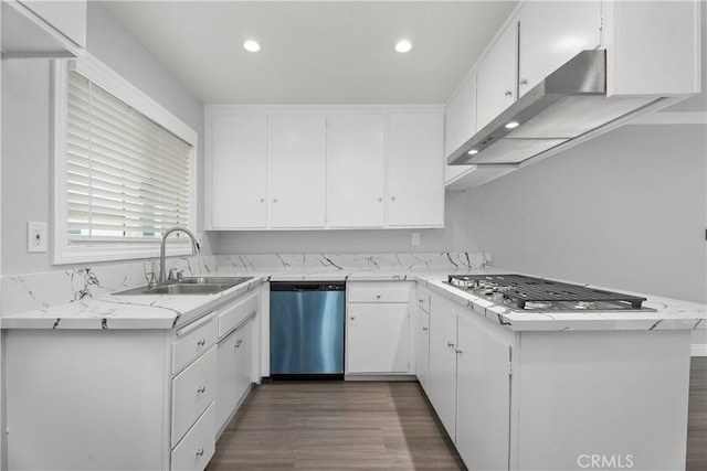 1440 E Abila St, Carson, CA 90745 - kitchen with appliances with stainless steel finishes, wall chimney exhaust hood, white cabinetry, a sink, and dark wood-style floors