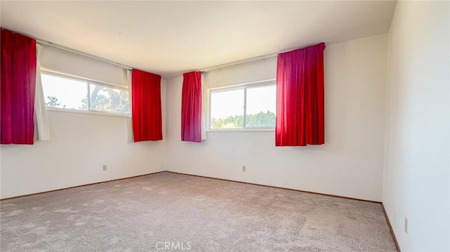 7411 Joshua Ln, Yucca Valley, CA 92284 - empty room with plenty of natural light, carpet, and baseboards