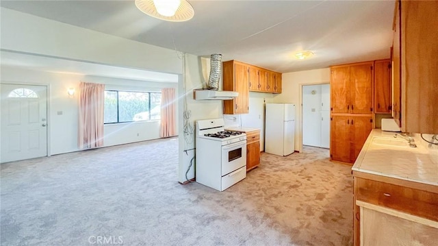 7411 Joshua Ln, Yucca Valley, CA 92284 - kitchen with white appliances, a sink, brown cabinetry, and light colored carpet
