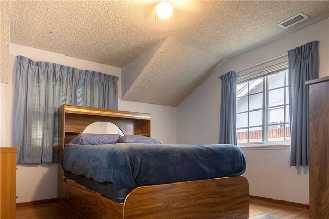 13372 Newhope St, Garden Grove, CA 92843 - bedroom featuring a textured ceiling, wood finished floors, vaulted ceiling, and baseboards