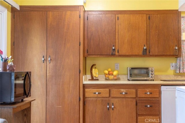 13372 Newhope St, Garden Grove, CA 92843 - kitchen with white dishwasher, black microwave, brown cabinets, and light countertops