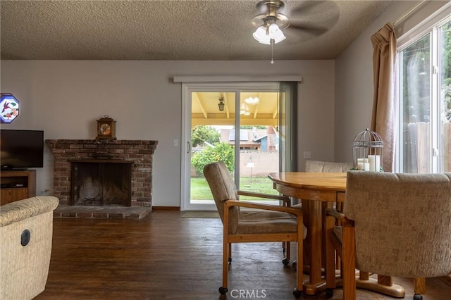 13372 Newhope St, Garden Grove, CA 92843 - dining room featuring a ceiling fan, a textured ceiling, wood finished floors, and a fireplace