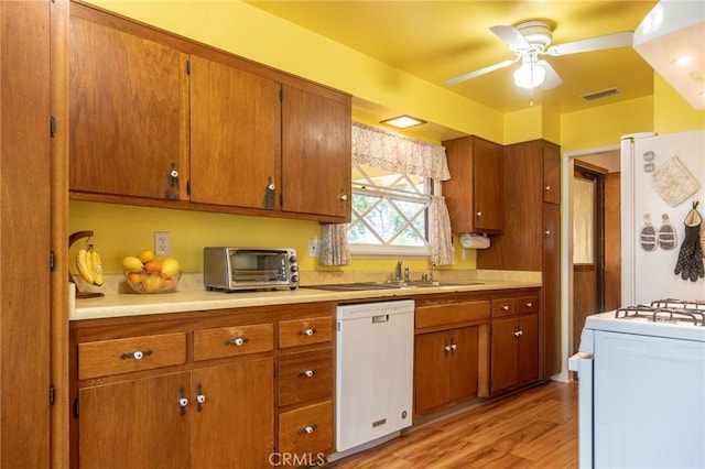 13372 Newhope St, Garden Grove, CA 92843 - kitchen with white appliances, ceiling fan, light wood-type flooring, brown cabinets, and light countertops