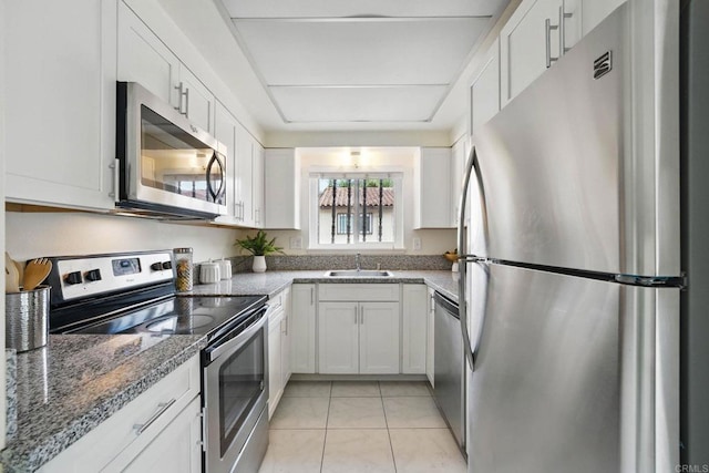 12234 Rancho Bernardo Rd Unit A, Rancho Bernardo San Diego, CA 92128 - kitchen with stainless steel appliances, a sink, white cabinets, light tile patterned floors, and stone countertops