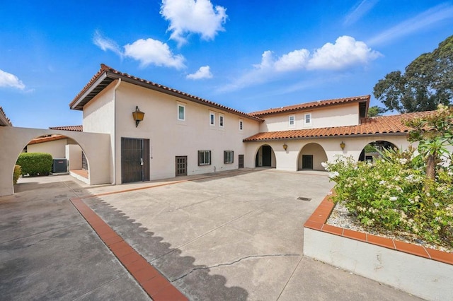 12234 Rancho Bernardo Rd Unit A, Rancho Bernardo San Diego, CA 92128 - rear view of house featuring stucco siding, a tiled roof, a patio area, and central air condition unit