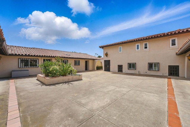 12234 Rancho Bernardo Rd Unit A, Rancho Bernardo San Diego, CA 92128 - back of property with stucco siding, a tiled roof, and a patio area