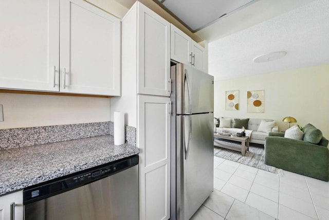 12234 Rancho Bernardo Rd Unit A, Rancho Bernardo San Diego, CA 92128 - kitchen featuring stainless steel appliances, white cabinets, light tile patterned flooring, and open floor plan