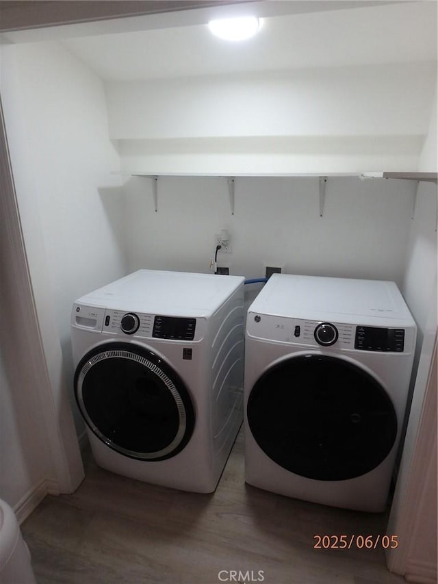 17457 Covello St, Van Nuys, CA 91406 - laundry room featuring washing machine and clothes dryer and wood finished floors