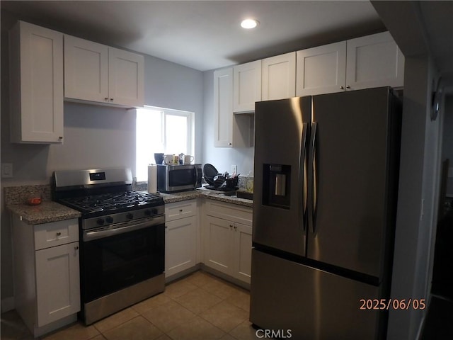 17457 Covello St, Van Nuys, CA 91406 - kitchen featuring appliances with stainless steel finishes, white cabinetry, light tile patterned floors, and recessed lighting