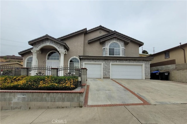 1389 Hillside St, Monterey Park, CA 91754 - view of front of property featuring stucco siding, an attached garage, concrete driveway, and stone siding