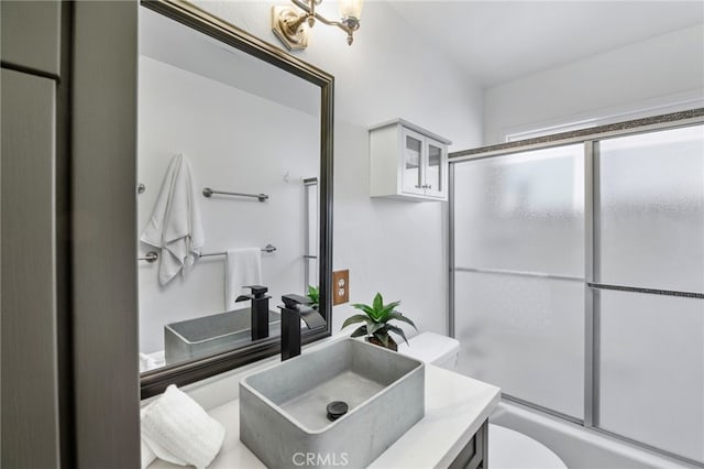 39335 Lark Rd, Big Bear Lake, CA 92315 - full bathroom featuring toilet, vanity, and shower / bath combination with glass door