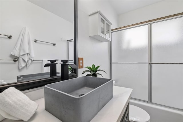 39335 Lark Rd, Big Bear Lake, CA 92315 - full bath featuring toilet, bath / shower combo with glass door, and vanity
