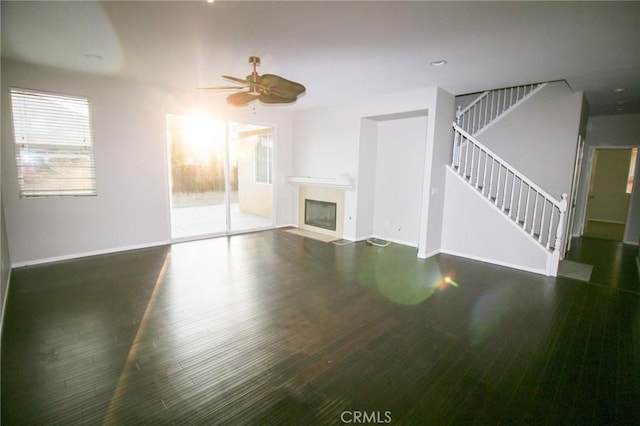 29113 Peppergrass Ave, Menifee, CA 92584 - unfurnished living room featuring stairway, a fireplace with flush hearth, ceiling fan, wood finished floors, and baseboards