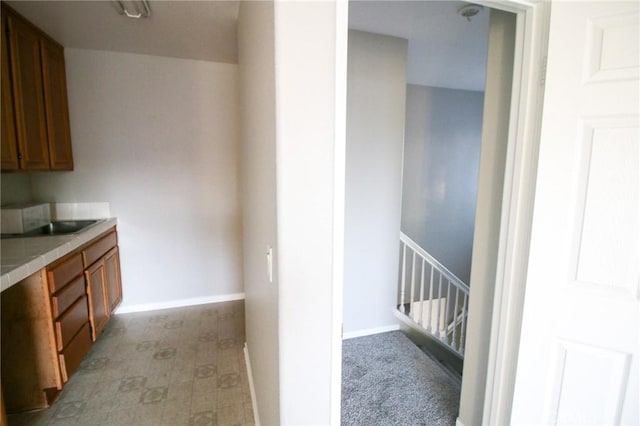 29113 Peppergrass Ave, Menifee, CA 92584 - kitchen with tile countertops, brown cabinets, baseboards, and a sink
