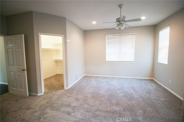 29113 Peppergrass Ave, Menifee, CA 92584 - unfurnished bedroom featuring carpet, a walk in closet, baseboards, a ceiling fan, and recessed lighting