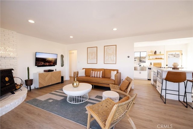 63326 Sunny Sands Dr, Joshua Tree, CA 92252 - living room with light wood finished floors, a wood stove, and recessed lighting