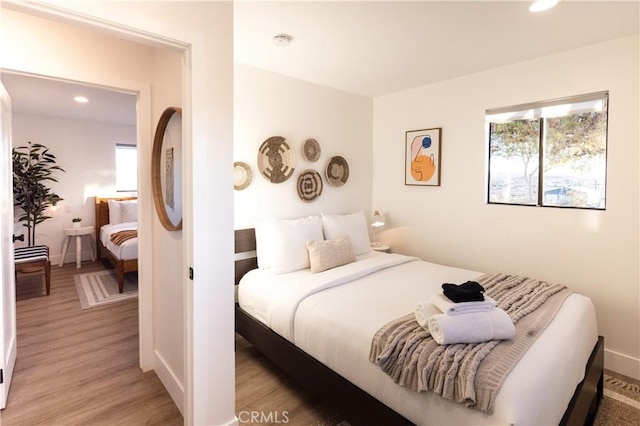 63326 Sunny Sands Dr, Joshua Tree, CA 92252 - bedroom featuring multiple windows, light wood-type flooring, recessed lighting, and baseboards