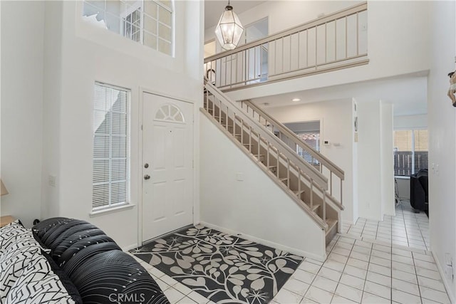 25213 Via Las Lomas, Murrieta, CA 92562 - entryway featuring stairs, a towering ceiling, and light tile patterned flooring