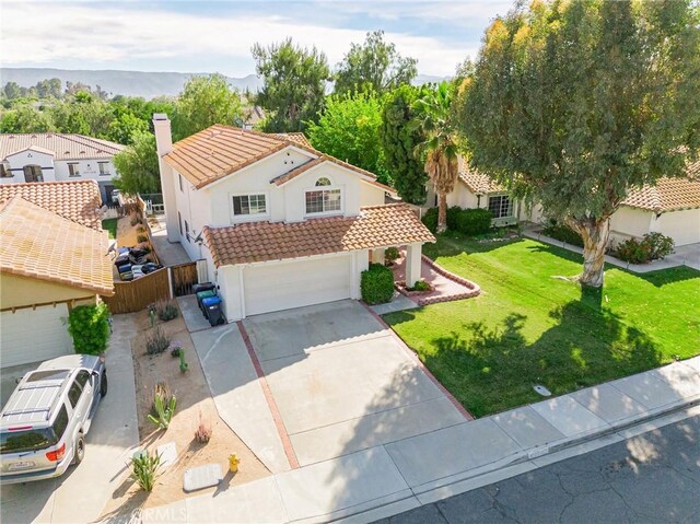 25213 Via Las Lomas, Murrieta, CA 92562 - mediterranean / spanish home with a tile roof, concrete driveway, stucco siding, a garage, and a chimney