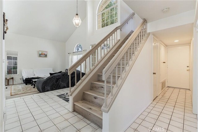 25213 Via Las Lomas, Murrieta, CA 92562 - staircase with high vaulted ceiling and tile patterned floors