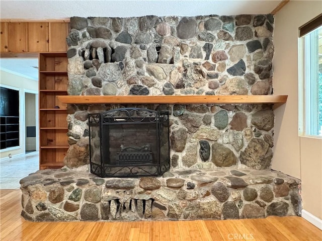 8 Geneva Ln, Chico, CA 95926 - detailed view of wood finished floors, a stone fireplace, ornamental molding, and baseboards