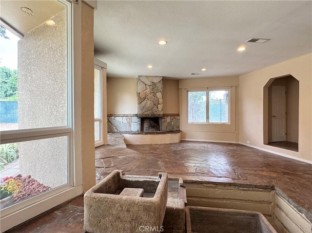 8 Geneva Ln, Chico, CA 95926 - unfurnished living room with baseboards, a fireplace, recessed lighting, and arched walkways