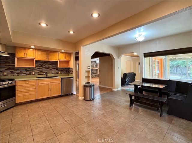 8 Geneva Ln, Chico, CA 95926 - kitchen featuring stainless steel appliances, a sink, arched walkways, baseboards, and decorative backsplash